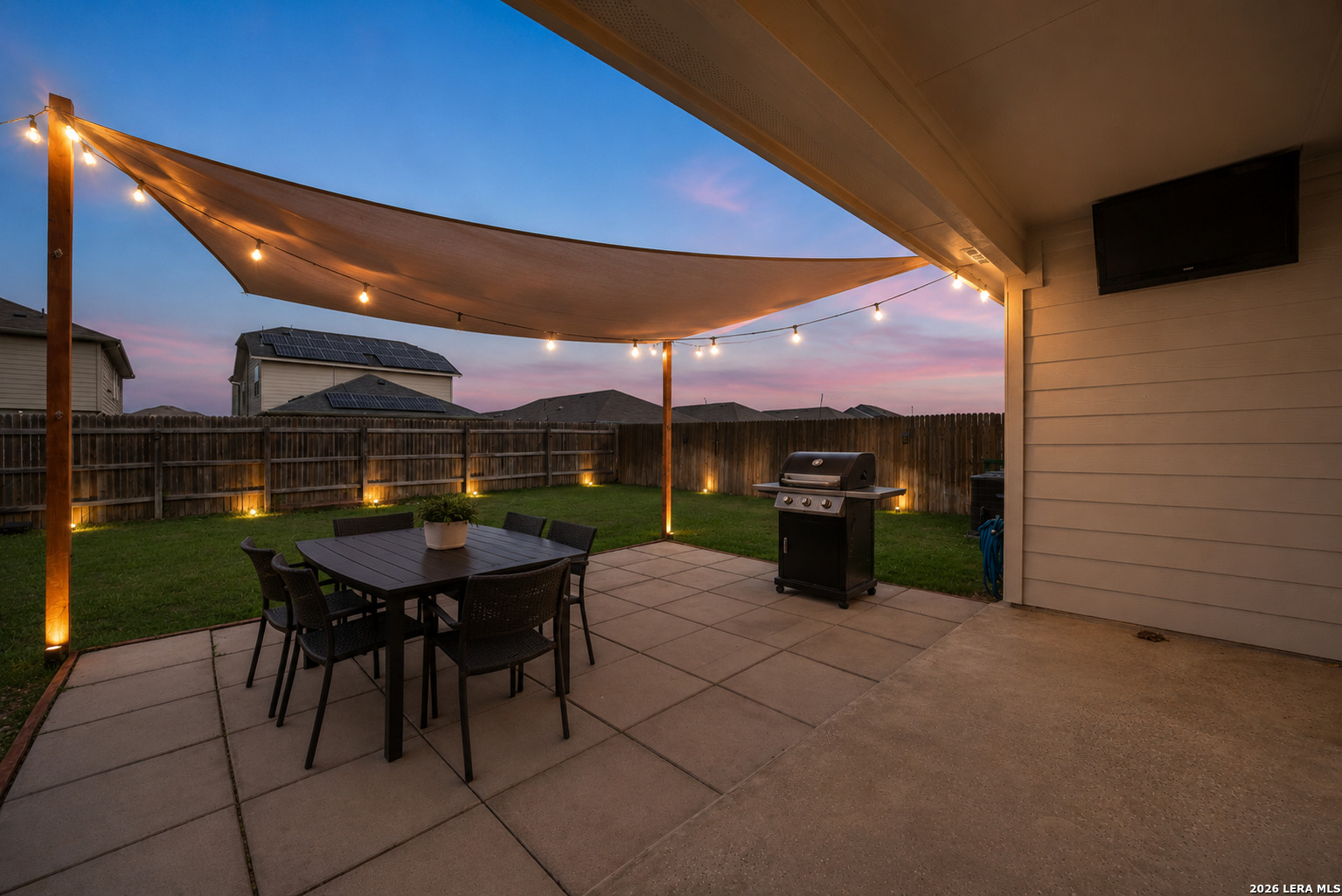 14809 Bajada Road Manor, TX 78653 - Photo 4 of 30 a view of a patio with table and chairs under an umbrella