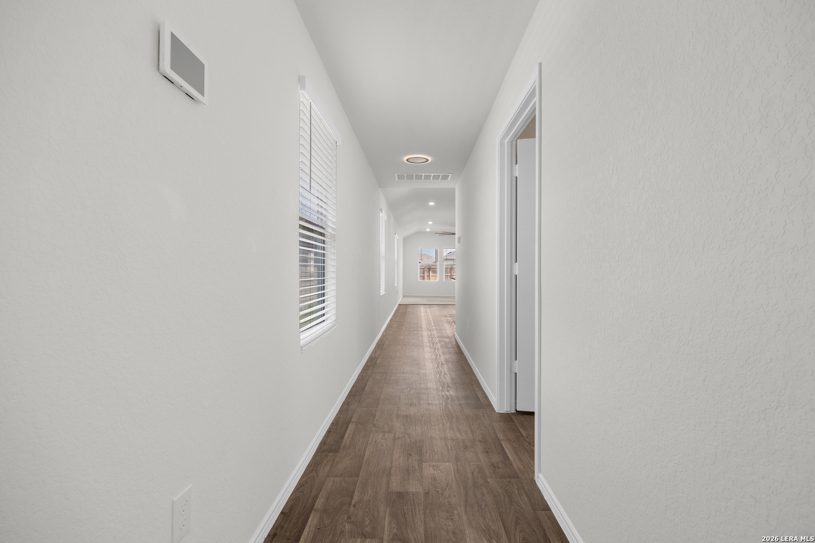 14809 Bajada Road Manor, TX 78653 - Photo 9 of 30 a view of a hallway with wooden floor and staircase