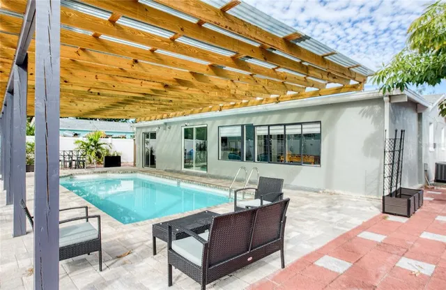 a view of a house with backyard and sitting area