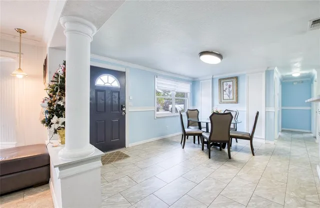 a view of a dining room with furniture and chandelier