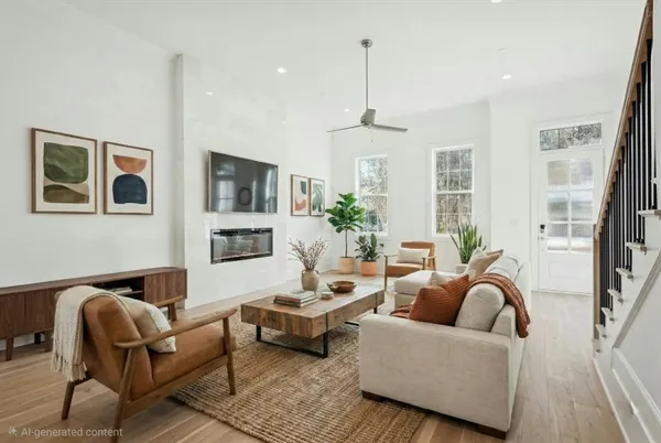 a living room with furniture ceiling fan and a rug