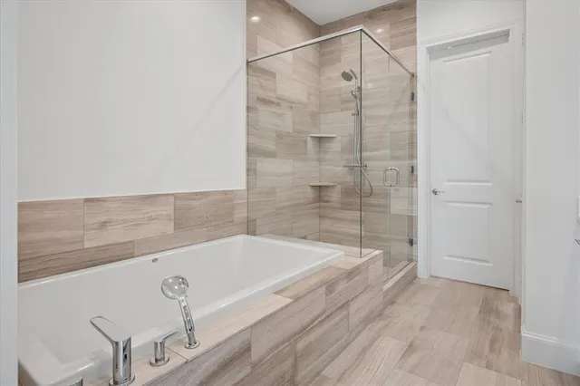 a bathroom with a bathtub and shower