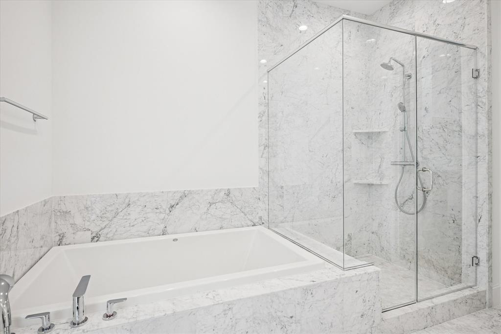 4066 Oak Circle Addison, TX 75001 - Photo 16 of 31 a bathroom with a bathtub and a shower