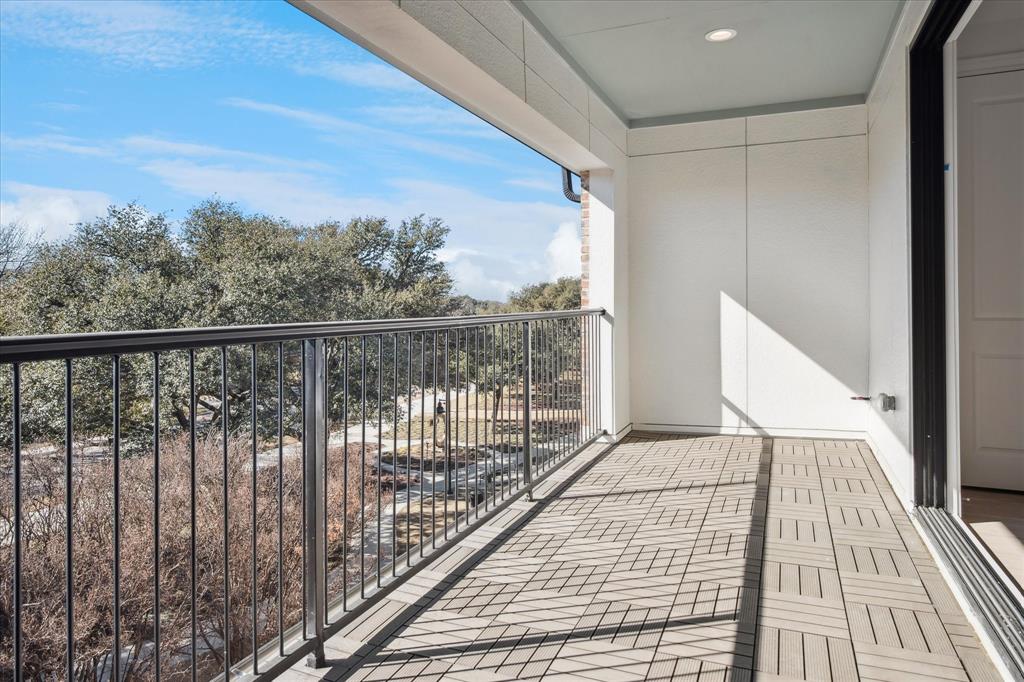 4066 Oak Circle Addison, TX 75001 - Photo 10 of 31 a balcony with wooden floor next to a large window