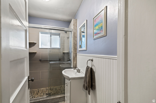 155 West Center Street Fillmore, UT 84631 - Photo 28 of 86 Bathroom with vanity, a stall shower, and a wainscoted wall