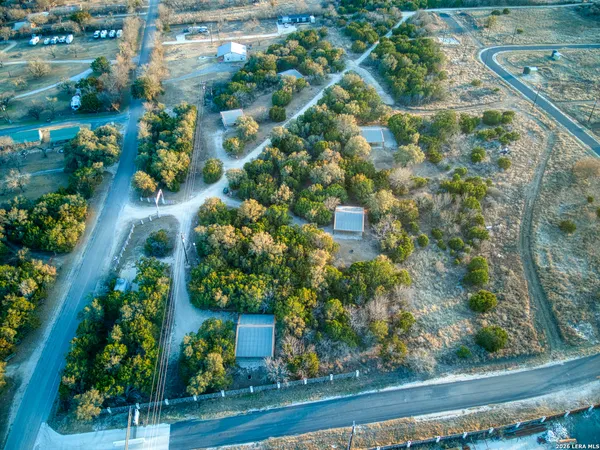 an aerial view of residential houses with outdoor space and street view