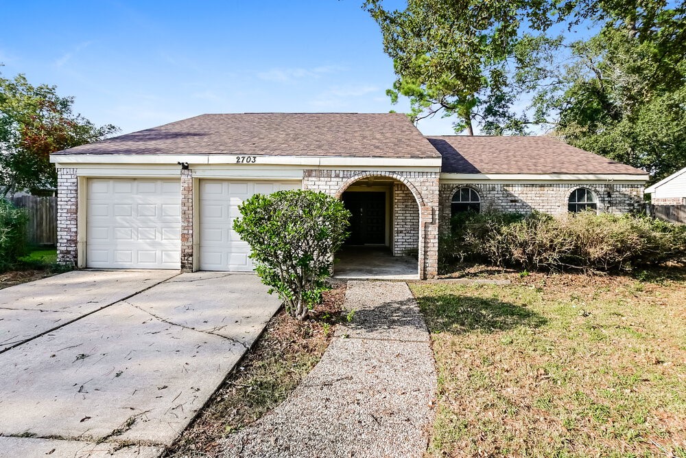front view of a house with potted plants