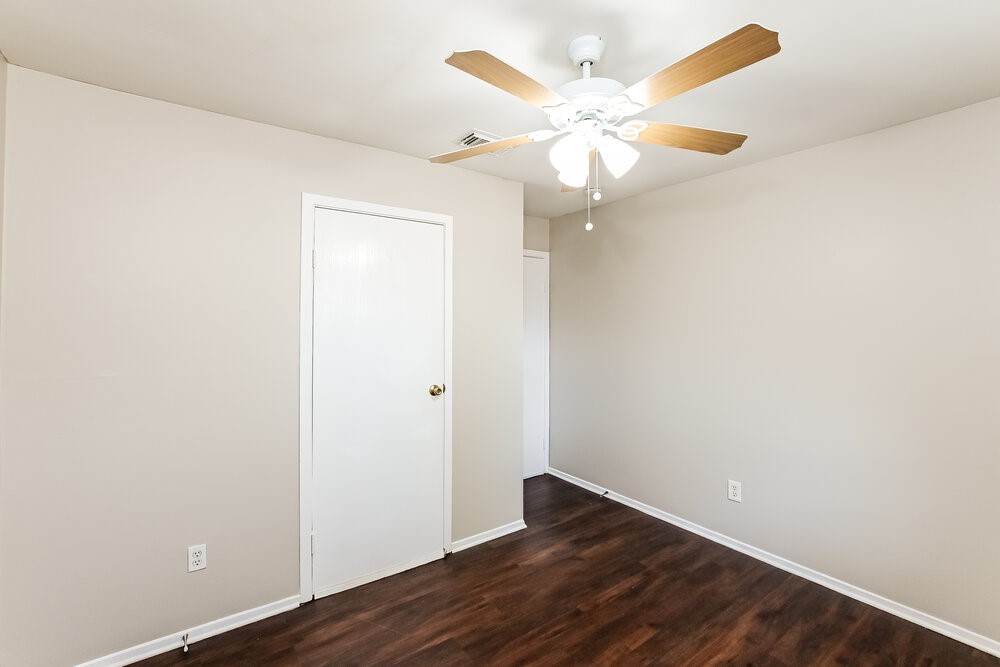 2703 Wood River Road Spring, TX 77373 - Photo 13 of 16 an empty room with wooden floor fan and window