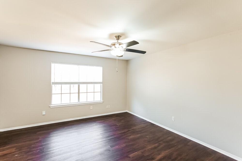 2703 Wood River Road Spring, TX 77373 - Photo 8 of 16 an empty room with wooden floor and windows