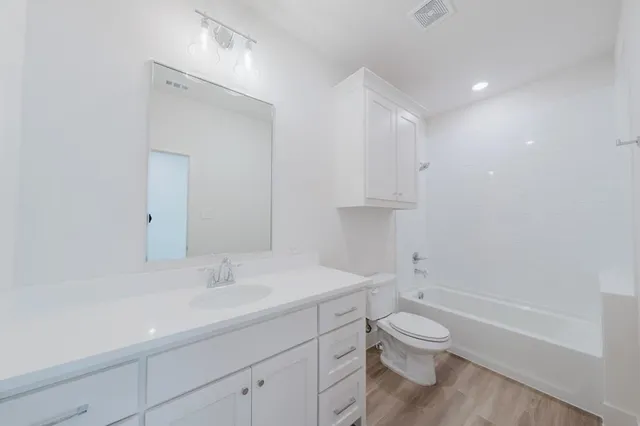 a bathroom with a toilet a sink and a bathtub