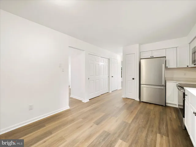 a view of a kitchen with a sink and a refrigerator