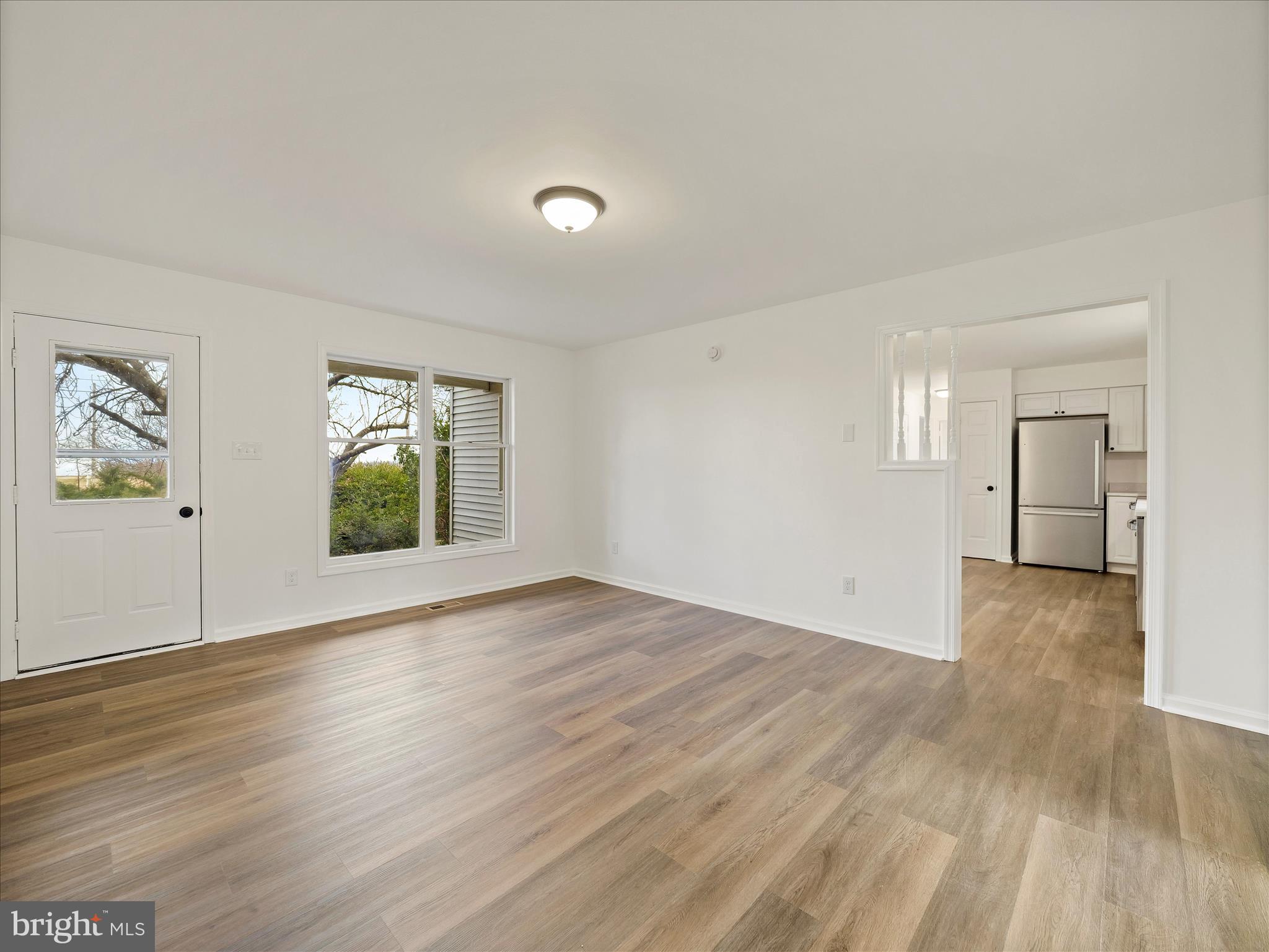6824 Rice Road Shippensburg, PA 17257 - Photo 14 of 35 an empty room with wooden floor and windows