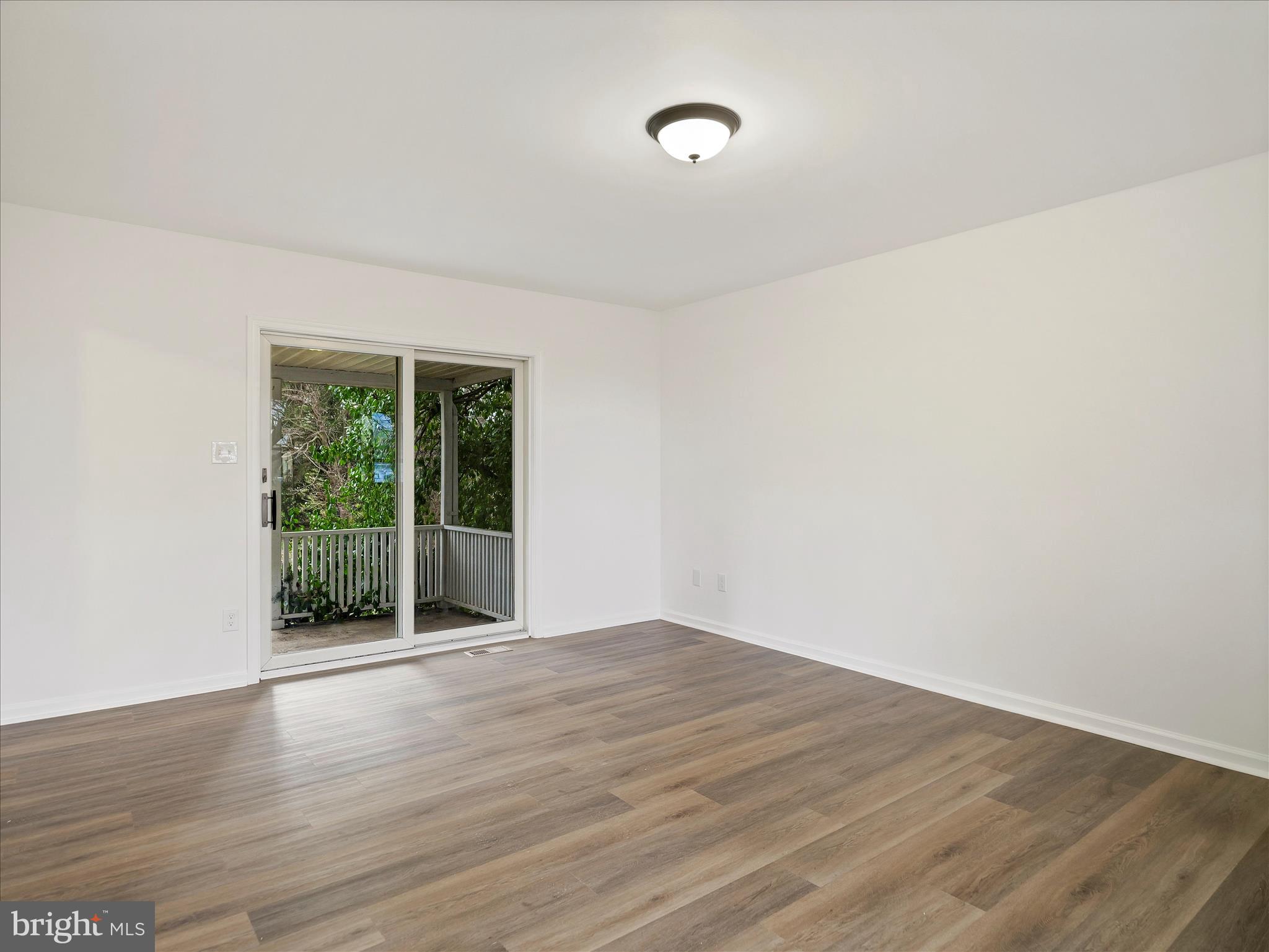 6824 Rice Road Shippensburg, PA 17257 - Photo 16 of 35 a view of an empty room with wooden floor and a window