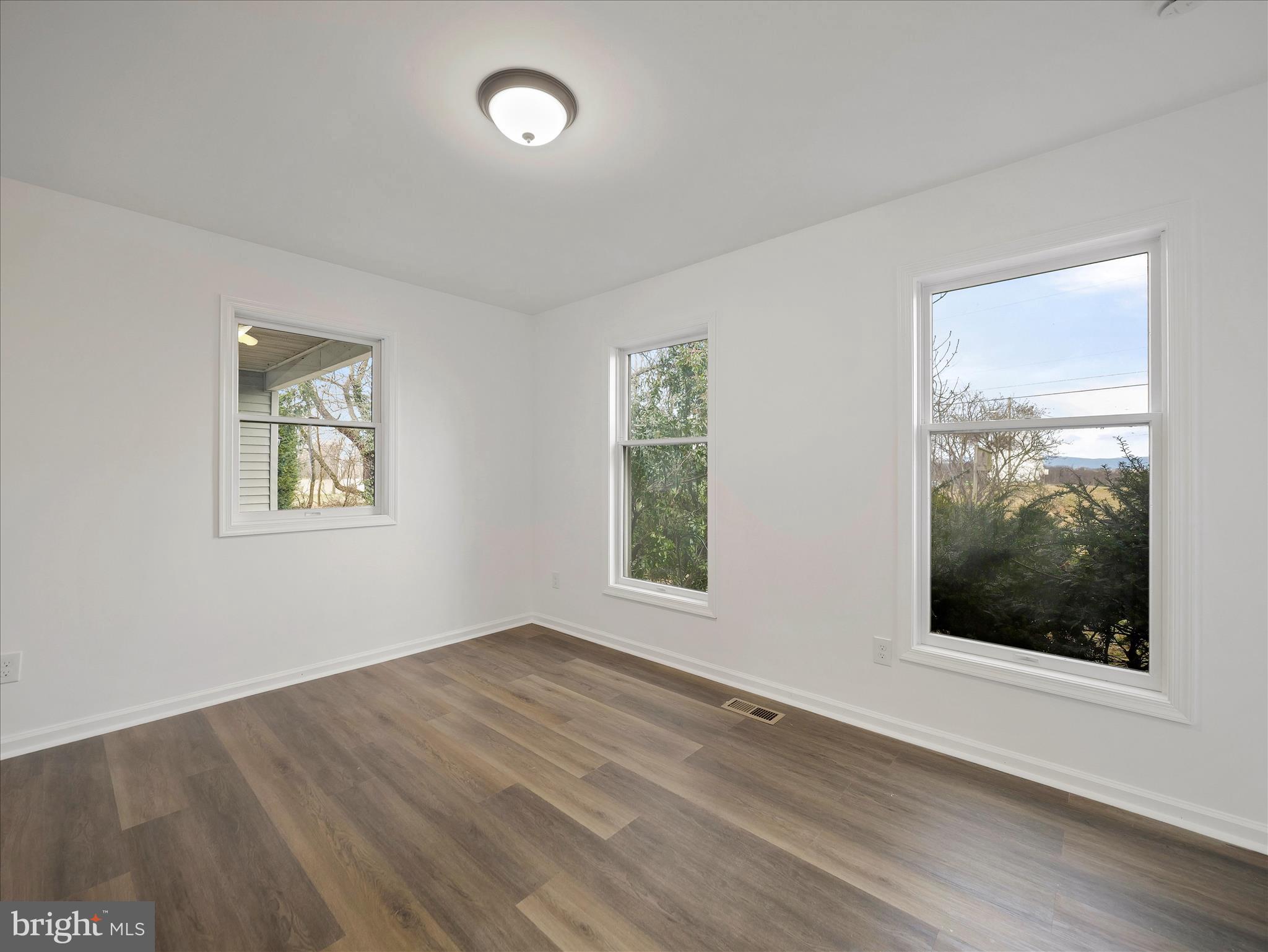 6824 Rice Road Shippensburg, PA 17257 - Photo 19 of 35 a view of an empty room with wooden floor and a window