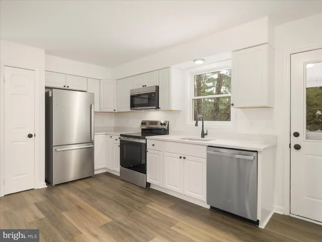 a kitchen with a refrigerator stove and sink