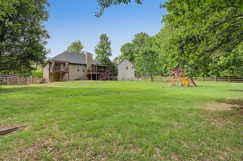 409 Windsor Way Canton, GA 30115 - Photo 39 of 51 a view of a house with a big yard and large trees