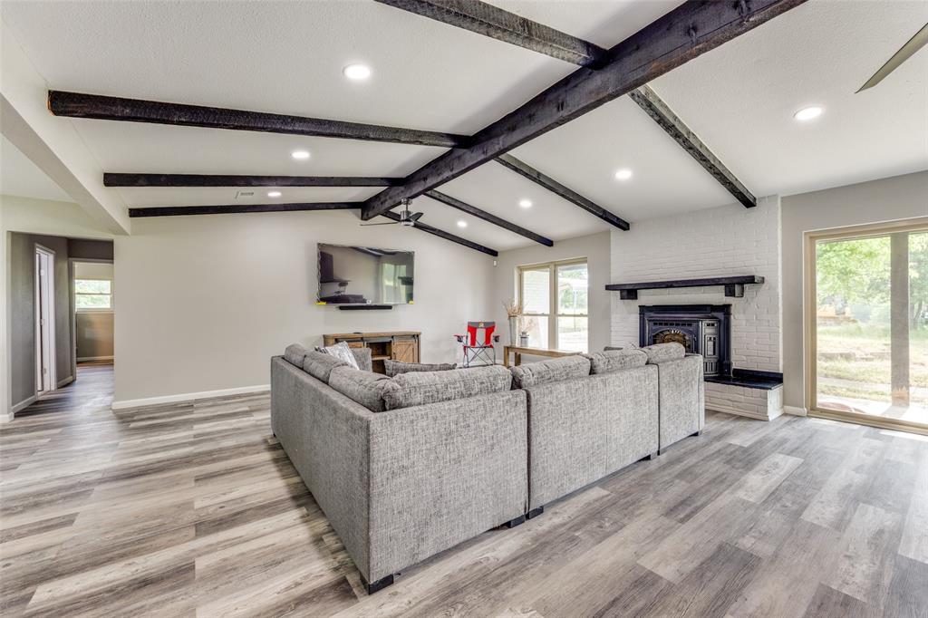 738 Campground Road Sherman, TX 75090 - Photo 17 of 40 a living room with furniture a fireplace and a flat screen tv