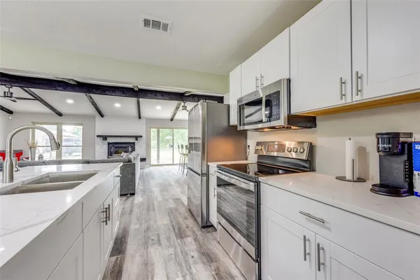a kitchen with a sink stove and cabinets