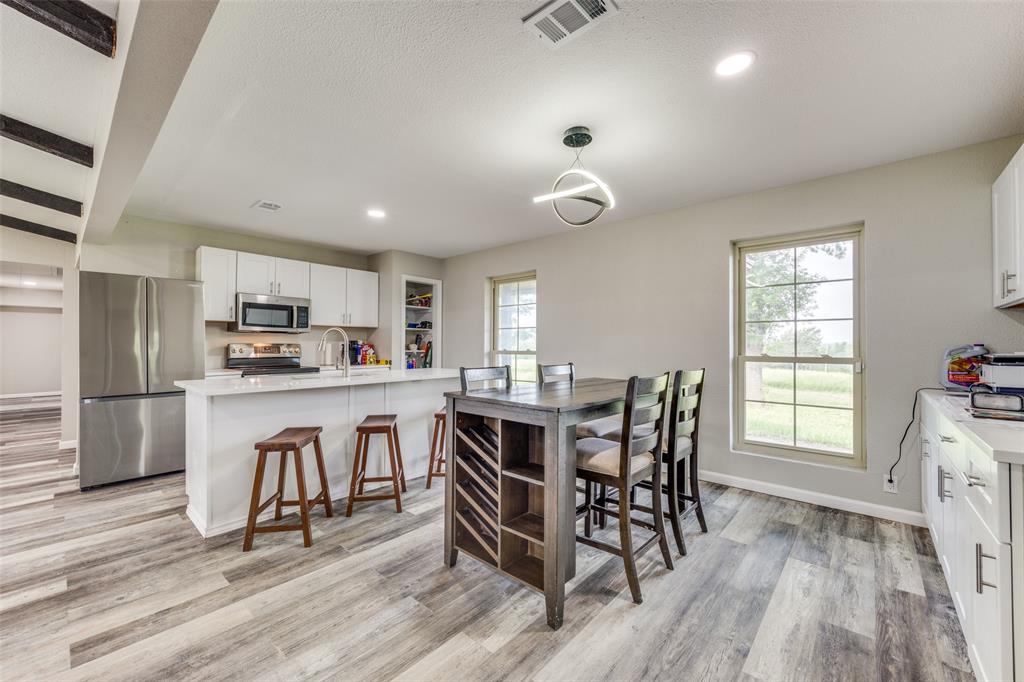 738 Campground Road Sherman, TX 75090 - Photo 19 of 40 a view of kitchen with dining table wooden floor and stainless steel appliances