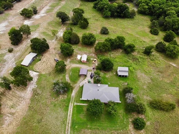 an aerial view of residential house with pool and yard