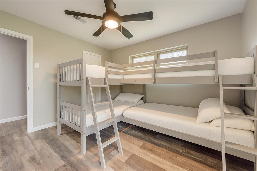 738 Campground Road Sherman, TX 75090 - Photo 31 of 40 a bedroom with a bed and a chandelier