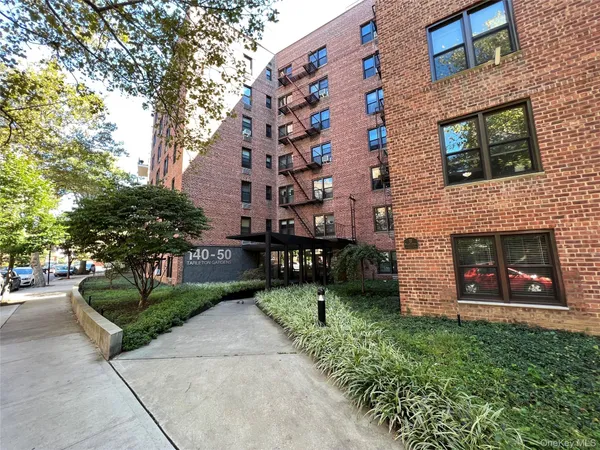 a front view of a house with a yard and a garage