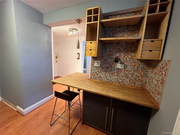 a view of a hallway with wooden floor and closet