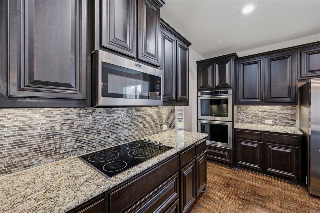 1215 The Trails Drive Blue Ridge, TX 75424 - Photo 10 of 40 Kitchen features Granite Counters, Electric Cooktop, Microwave, Double Oven and Plenty of Storage.