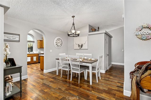 a view of a dining room with furniture wooden floor and a chandelier