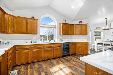 a large kitchen with stainless steel appliances granite countertop a sink and cabinets