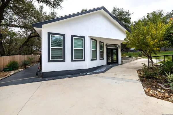 a front view of a house with a garden