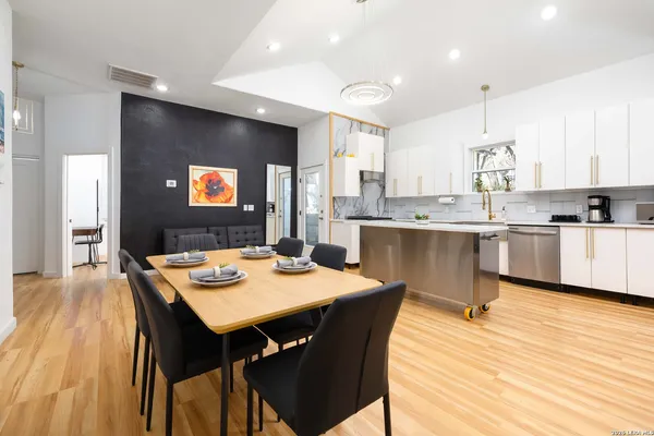 a large kitchen with a table and chairs