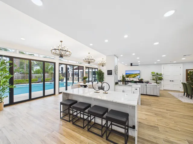 a dining room with furniture a chandelier and wooden floor