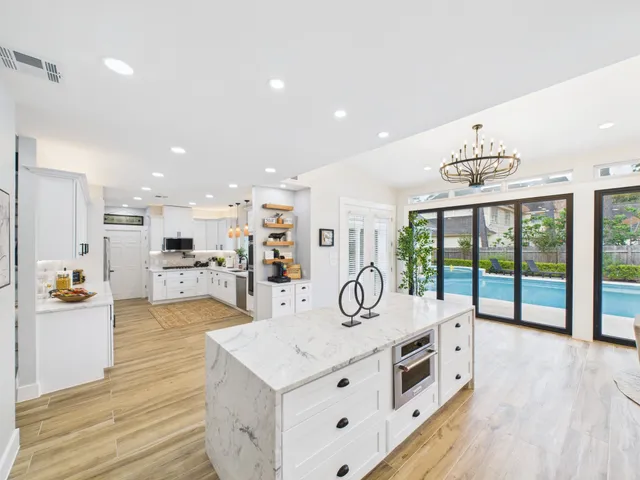 a kitchen with stainless steel appliances kitchen island granite countertop a stove and a sink