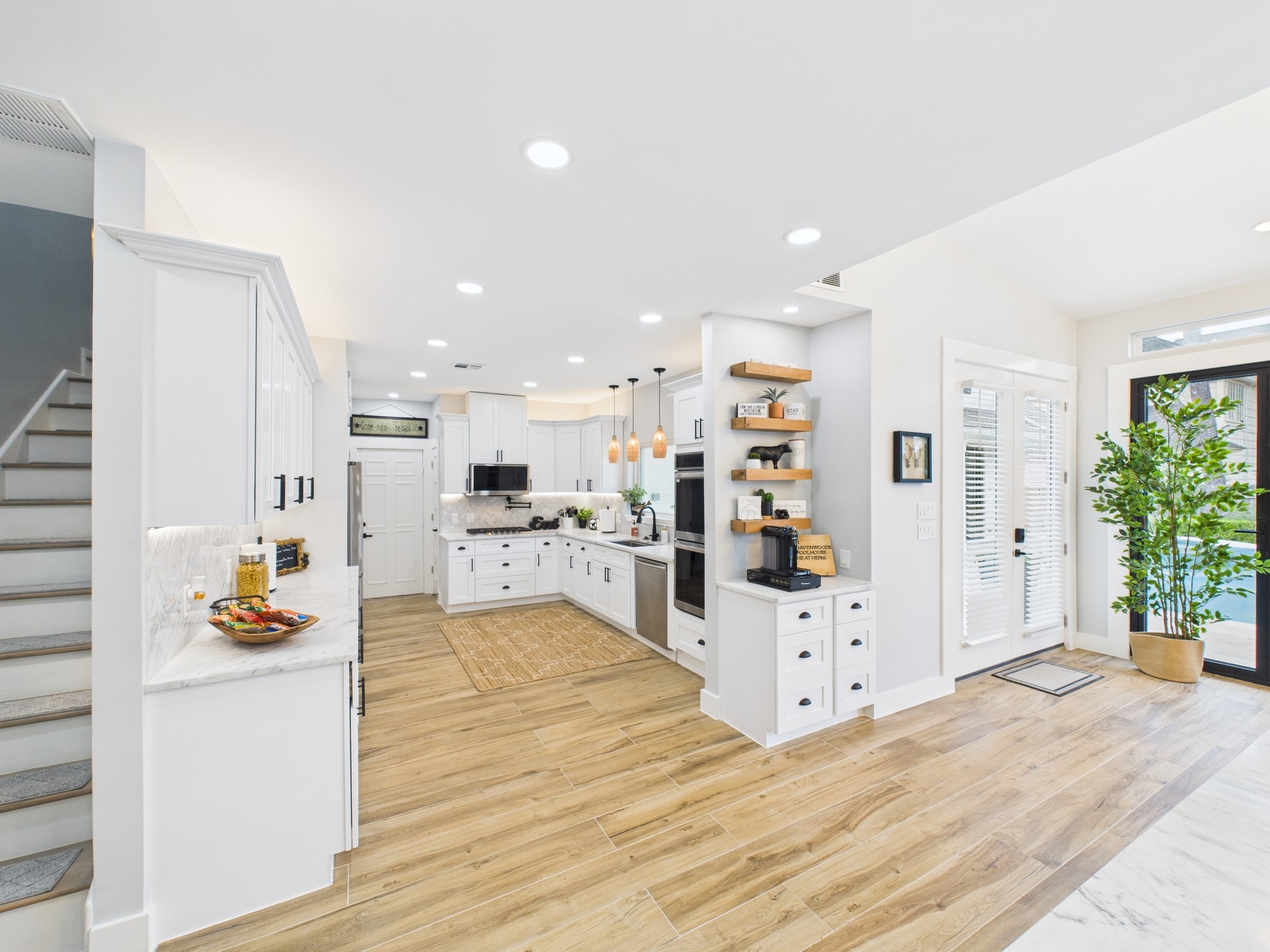 5430 Havenwoods Drive Houston, TX 77066 - Photo 14 of 50 a large white kitchen with cabinets and wooden floor