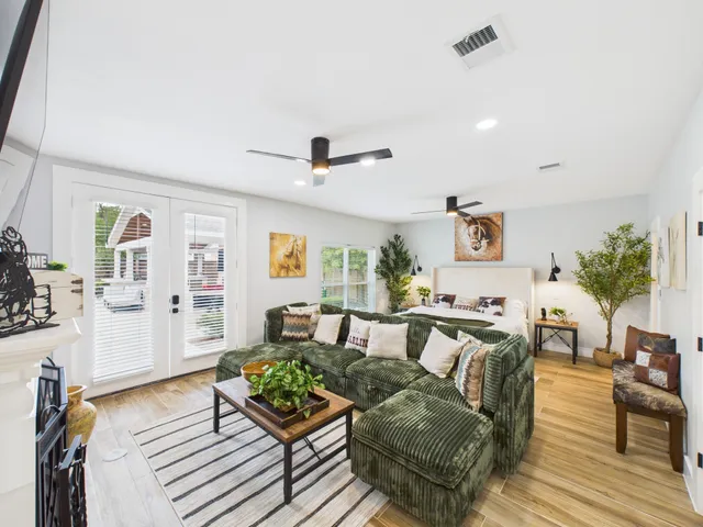 a living room with furniture and a wooden floor