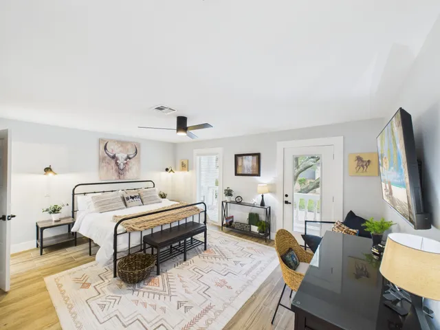 a bedroom with a bed a couch and dresser