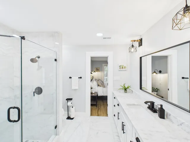 a bathroom with a tub sink and mirror