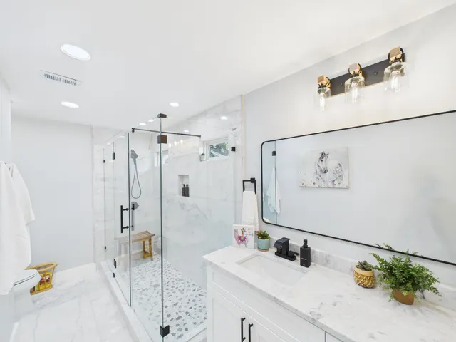 a bathroom with a sink mirror vanity and bathtub