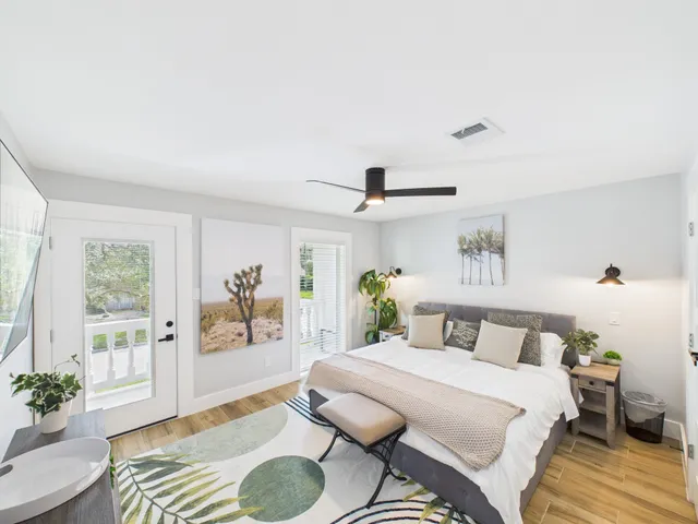 a bedroom with a bed and wooden floor