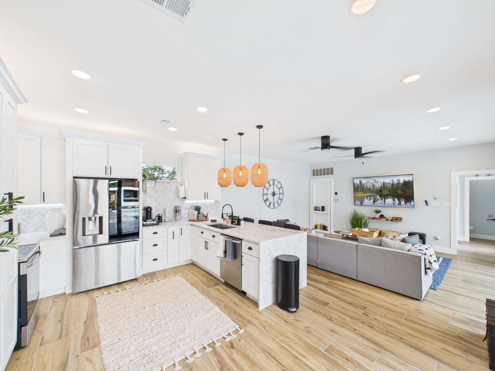 5430 Havenwoods Drive Houston, TX 77066 - Photo 40 of 50 a large white kitchen with stainless steel appliances kitchen island granite countertop a stove and a sink