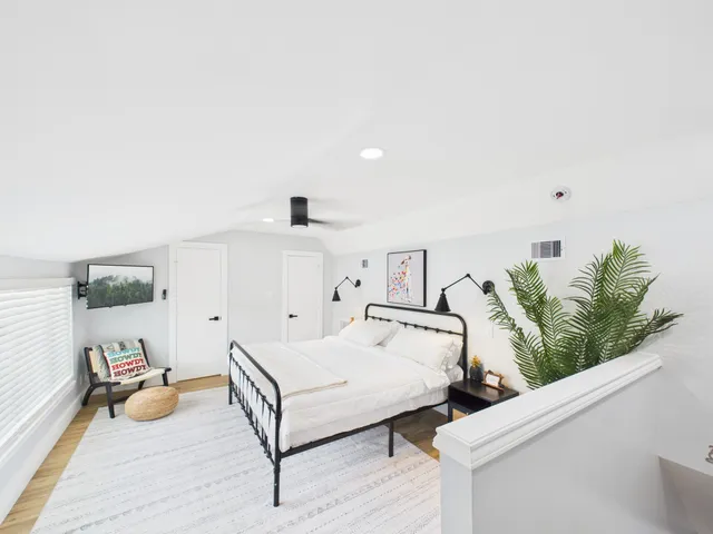 a bedroom with a bed and ceiling fan