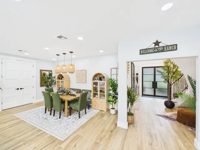 a view of a dining room with furniture and wooden floor