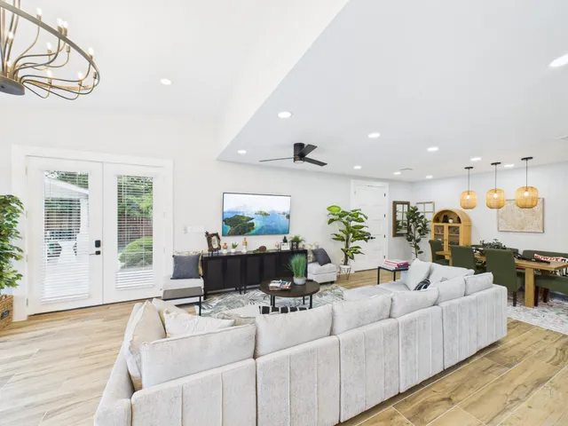 a living room with furniture and wooden floor