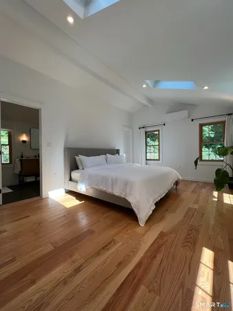 a bedroom with a bed and window