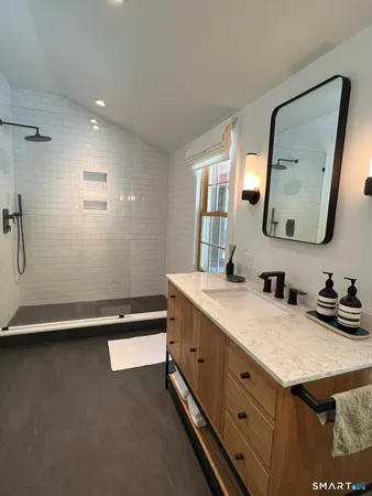a bathroom with a double vanity sink and a mirror