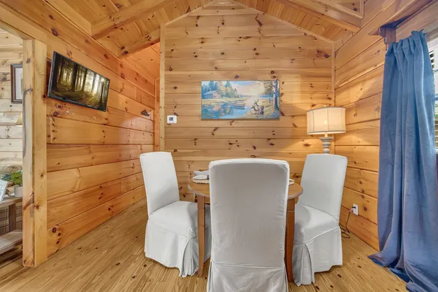 a dining room with furniture and wooden floor