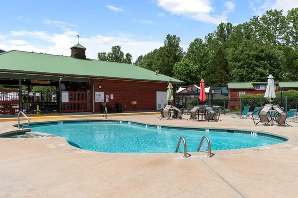 a view of a house with a yard and a patio