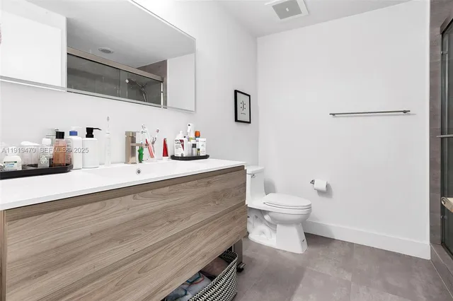 a bathroom with a sink a toilet and vanity