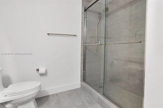a bathroom with a shower and toilet